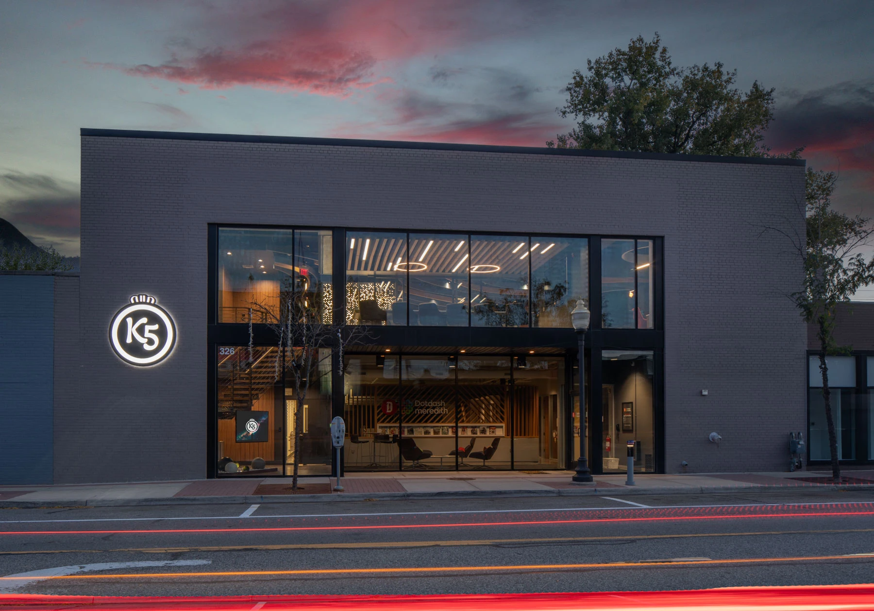 K5’s Royal Oak headquarters at dusk, with the studio visible through the glass façade