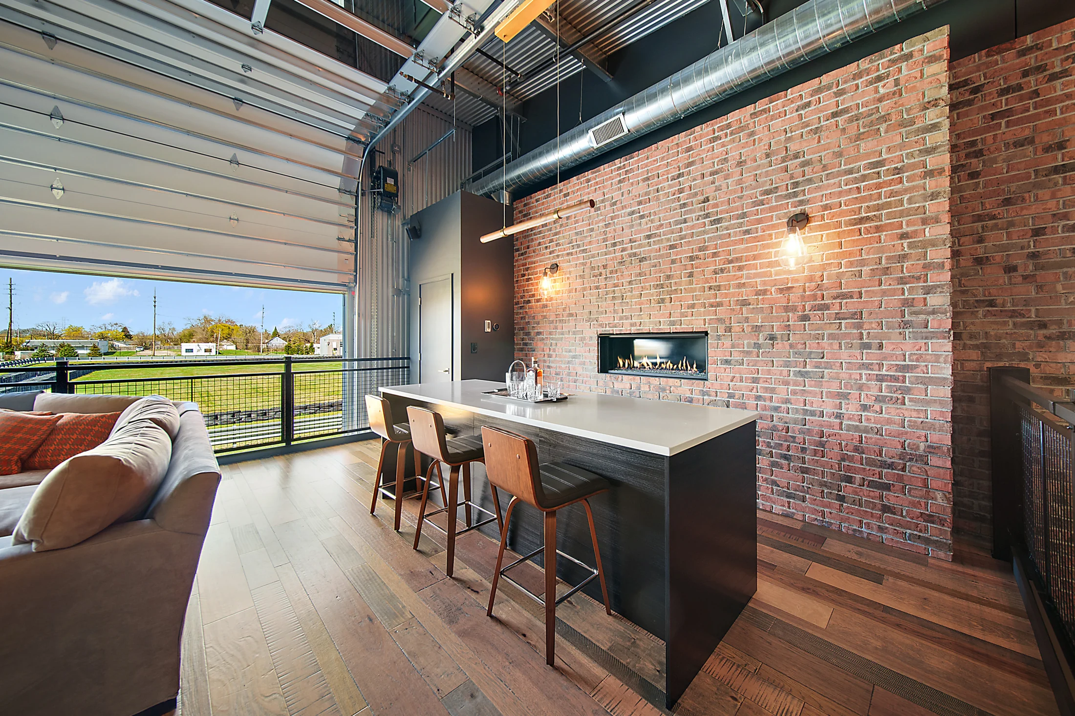 Unit 172 bar and kitchen, with exposed brick and warm timber flooring.