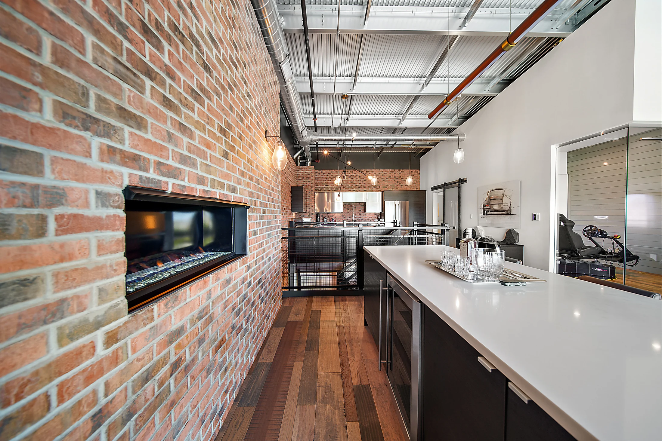 A long brick fireplace wall connects the bar and lounge at Unit 172.