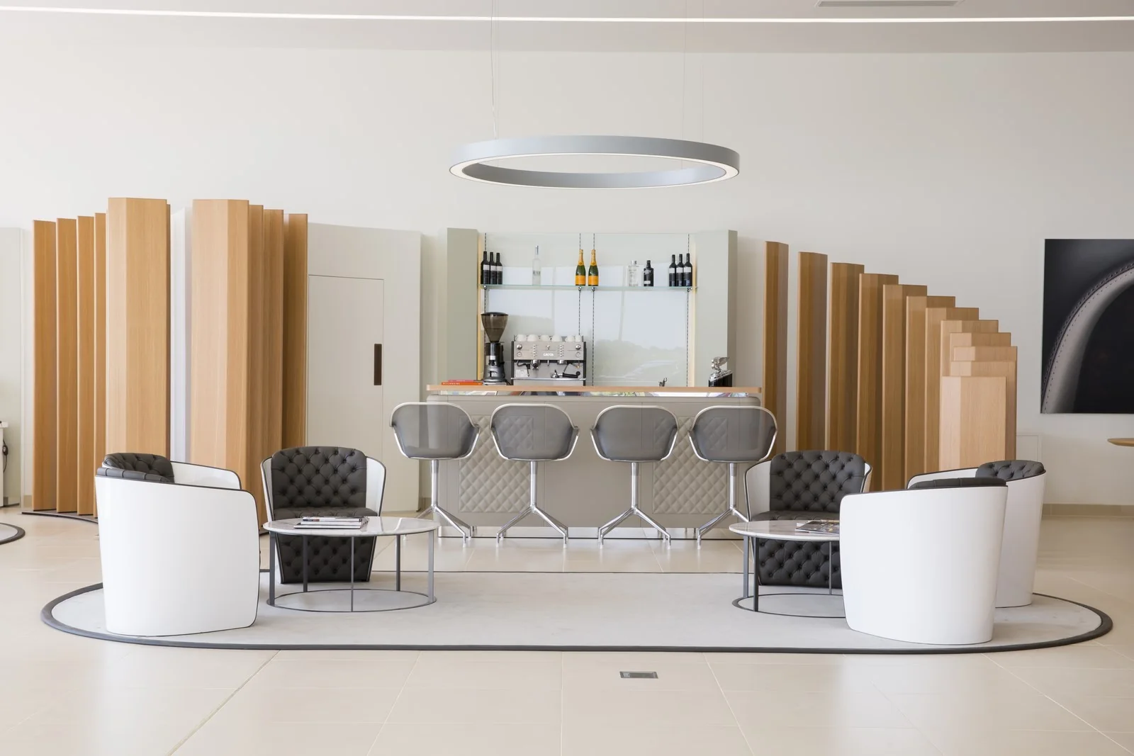 CW1 House / Vehicle display, hospitality and material choices form one environment.