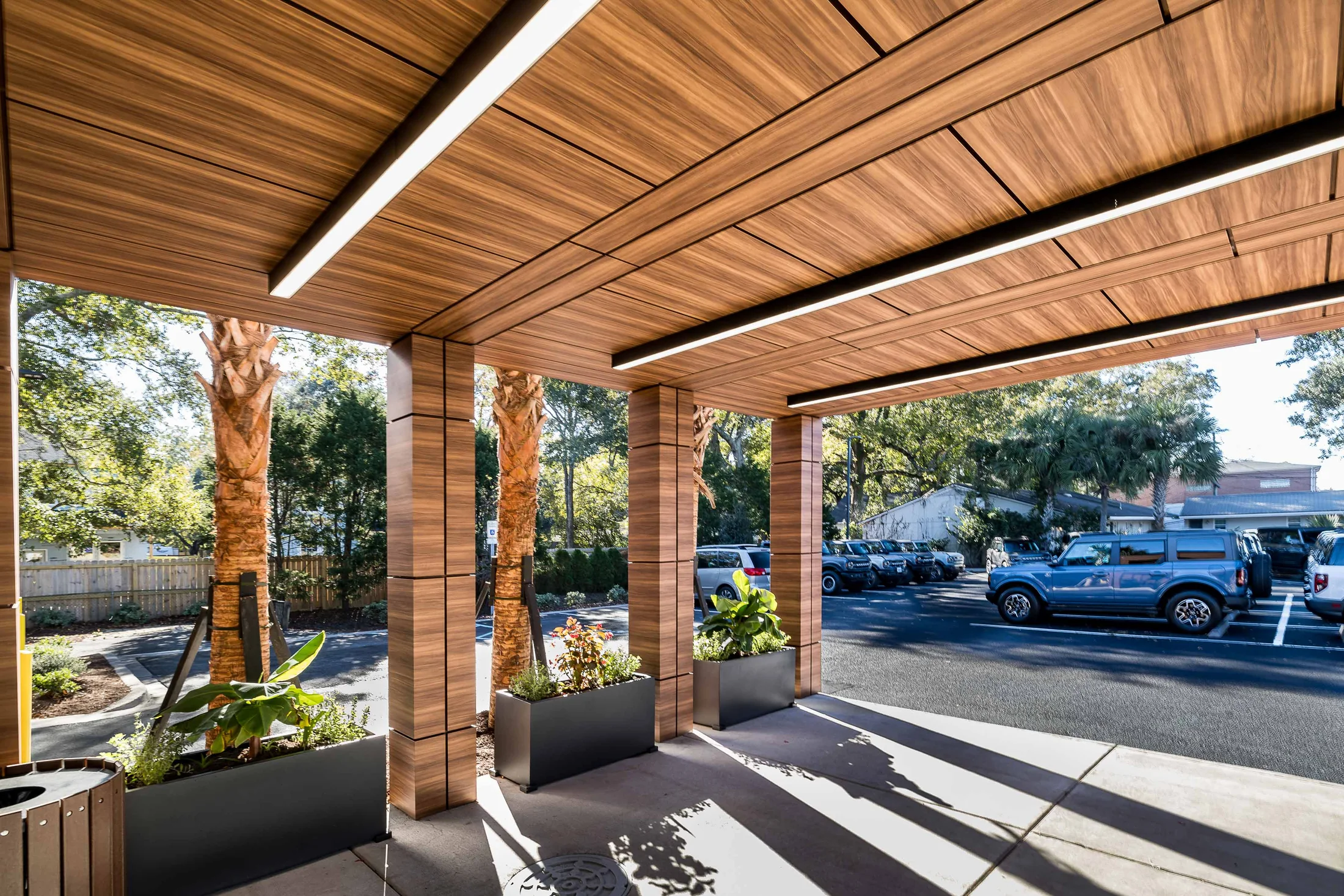 The covered porch creates a generous threshold between outdoors and showroom.