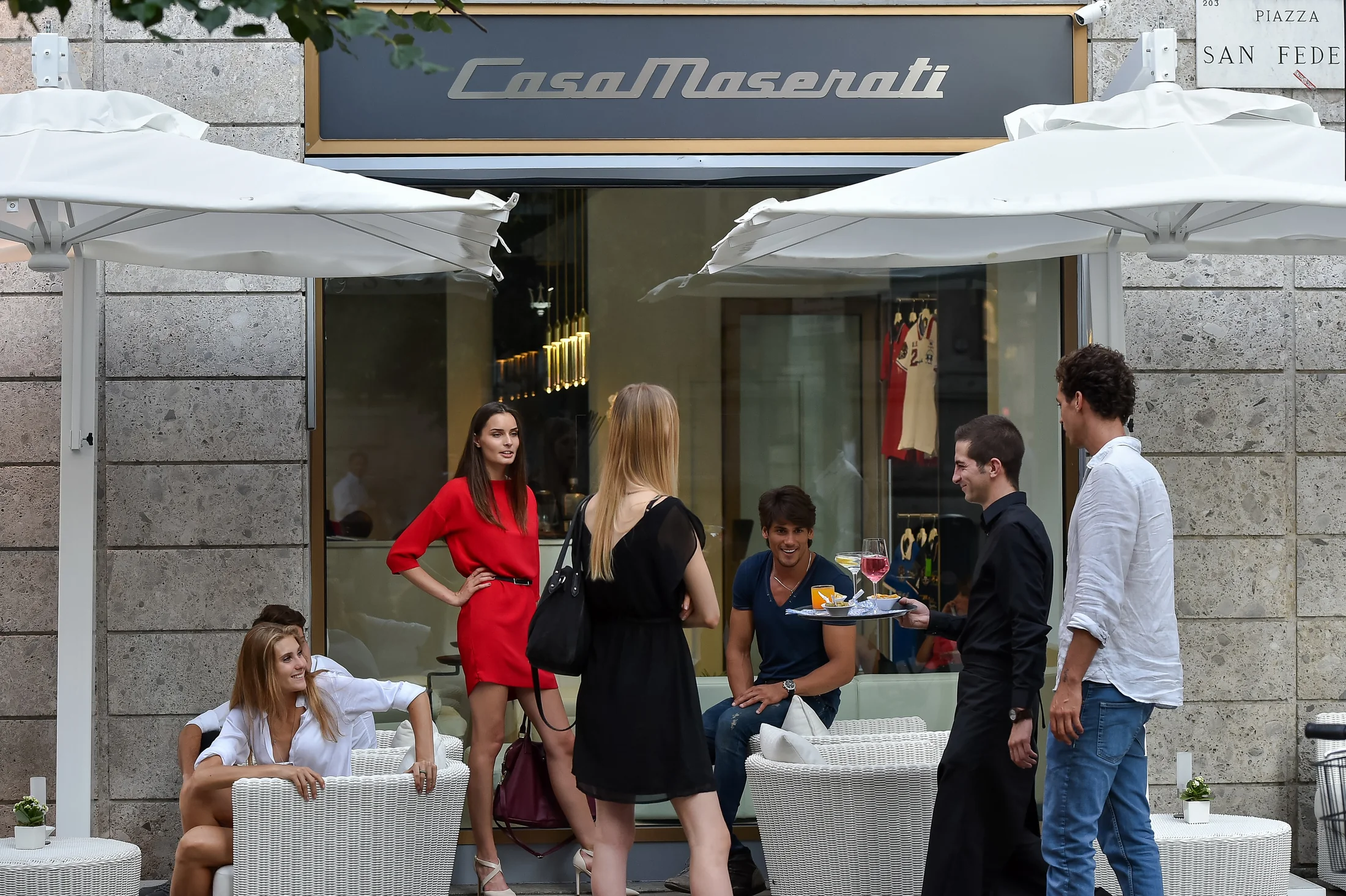 The street-facing destination opens onto the life of Piazza San Fedele.