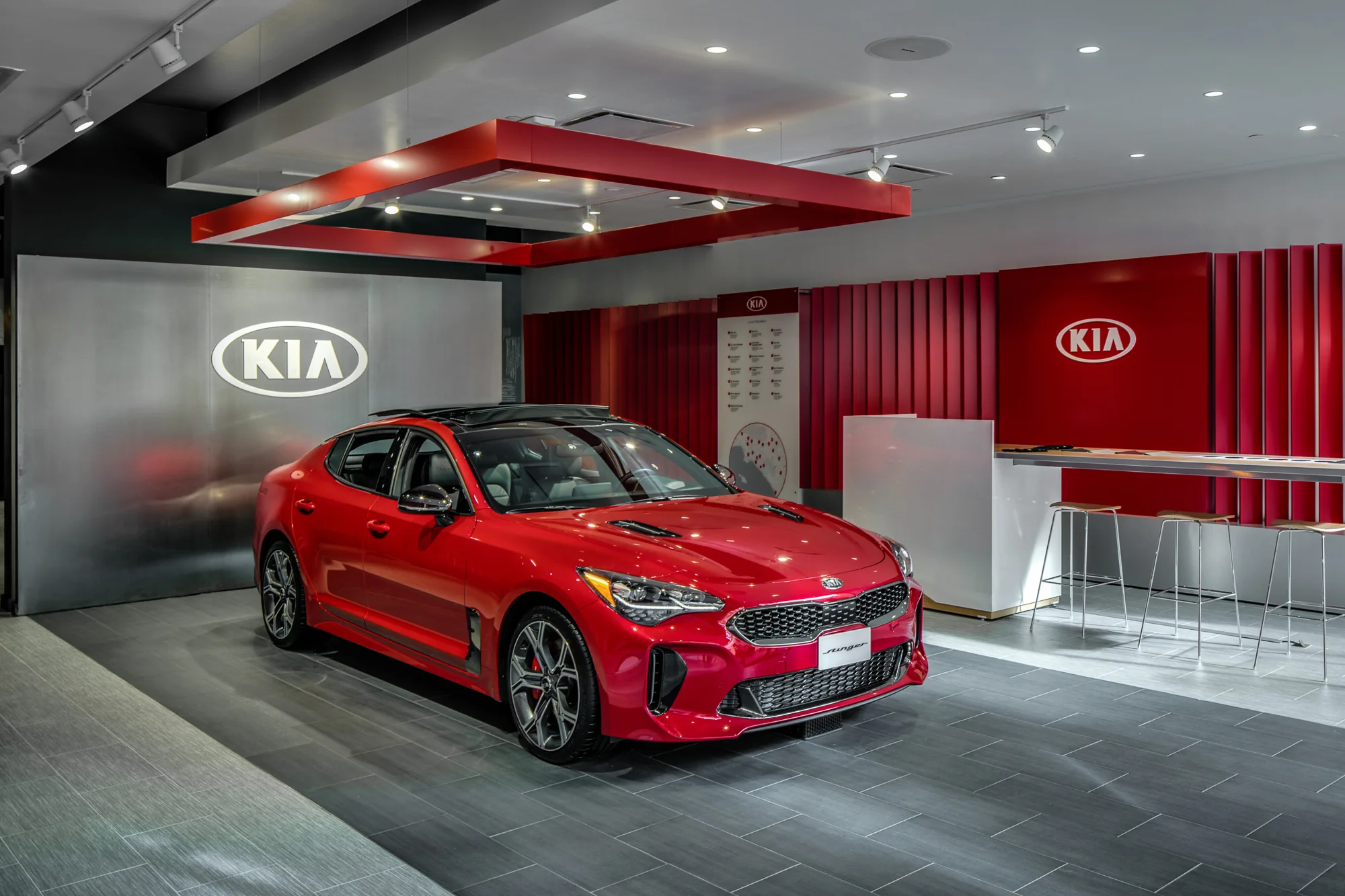 The Stinger takes center stage within a sequence of red architectural fins.