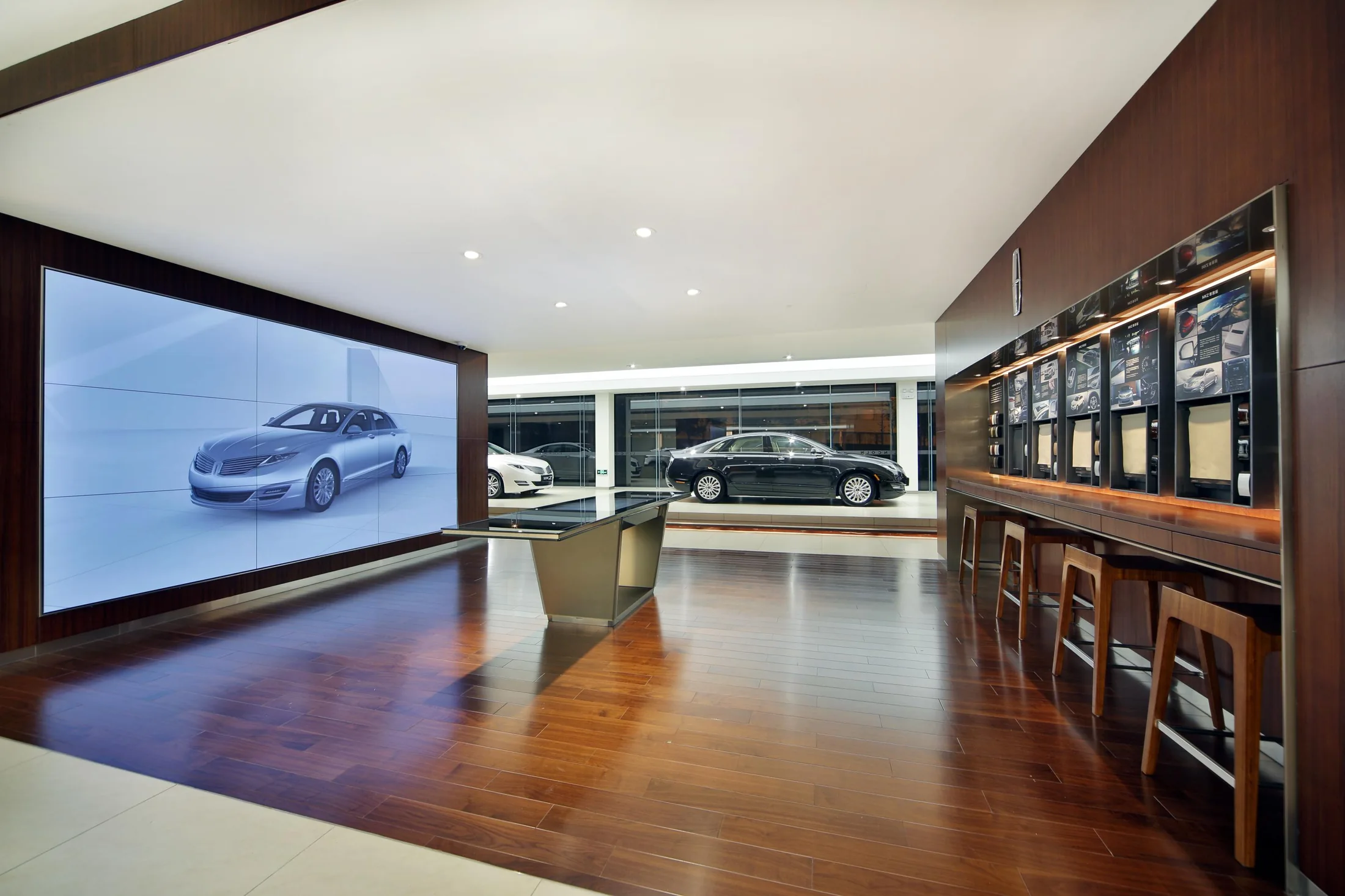 Digital presentation sits alongside material and merchandise displays.