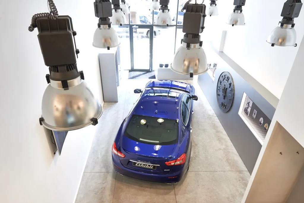 Knokke / The vehicle anchors the interior while retail extends around it.