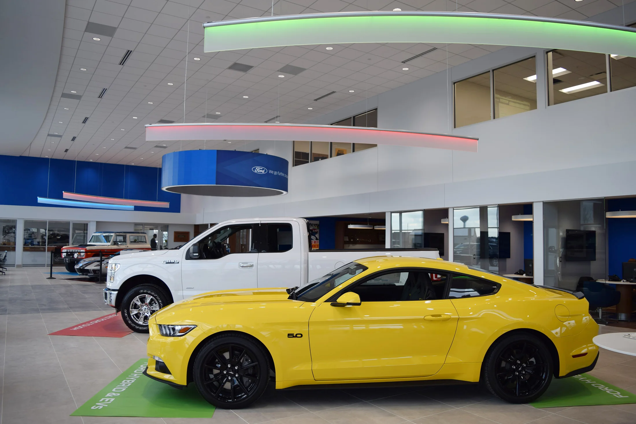 Lighting, color and the Ford identity organize the open showroom.