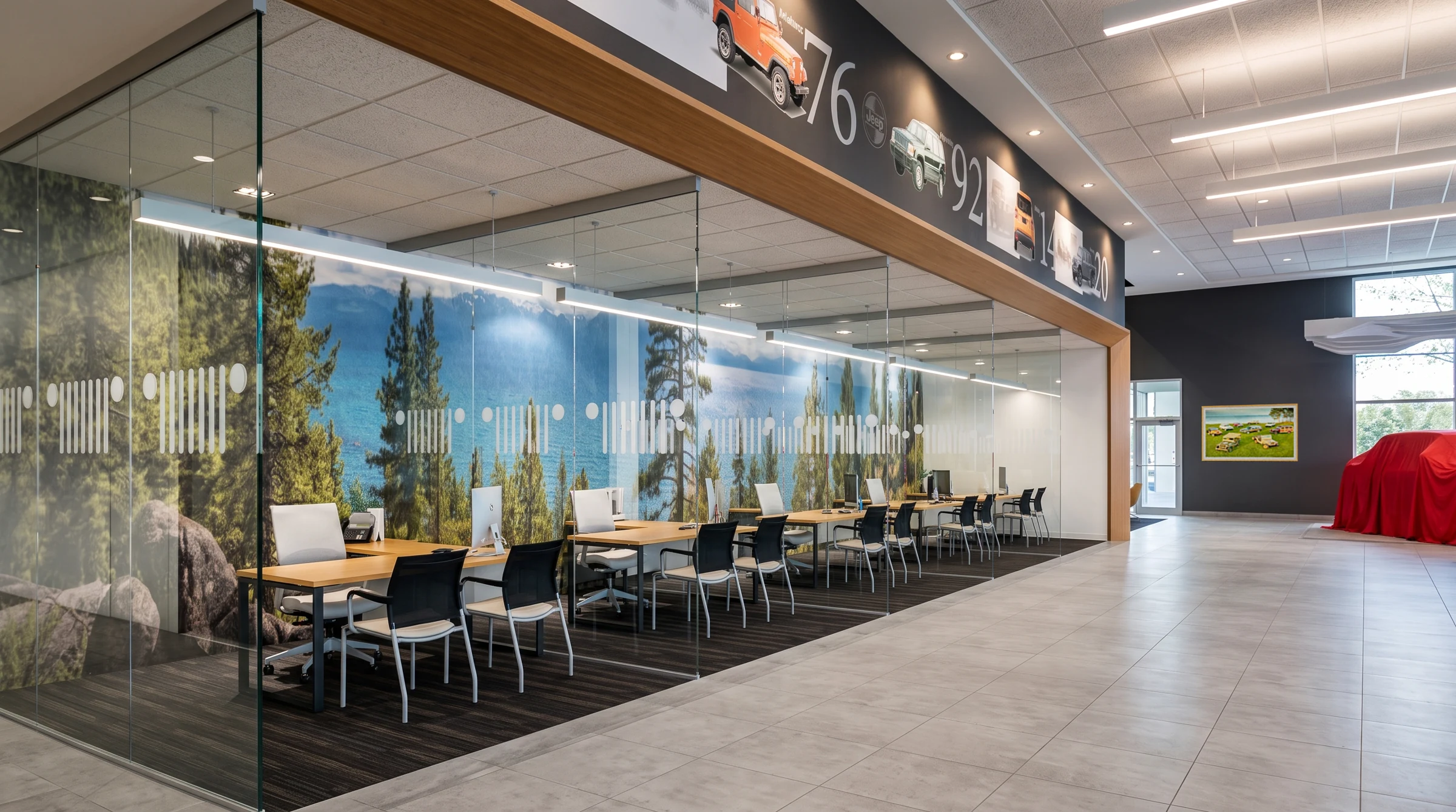 Glazed consultation spaces sit beside the vehicle showroom.