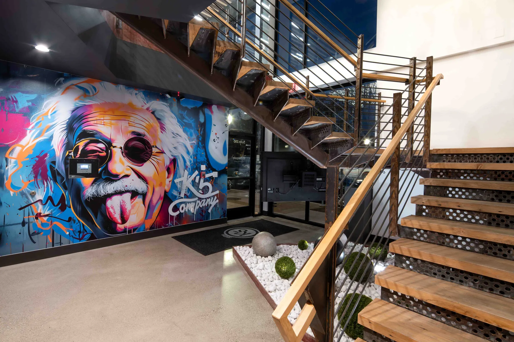 A central stair makes movement through the studio visible.