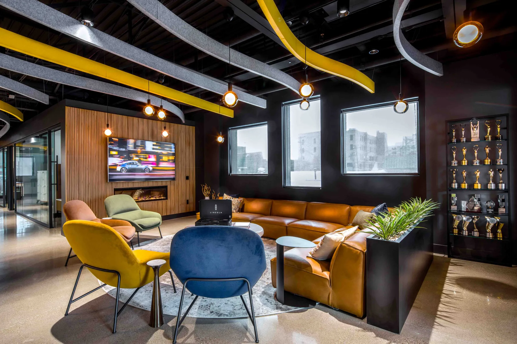 Hub 5 at K5 Headquarters, with lounge seating, a fireplace and sculptural ceiling panels
