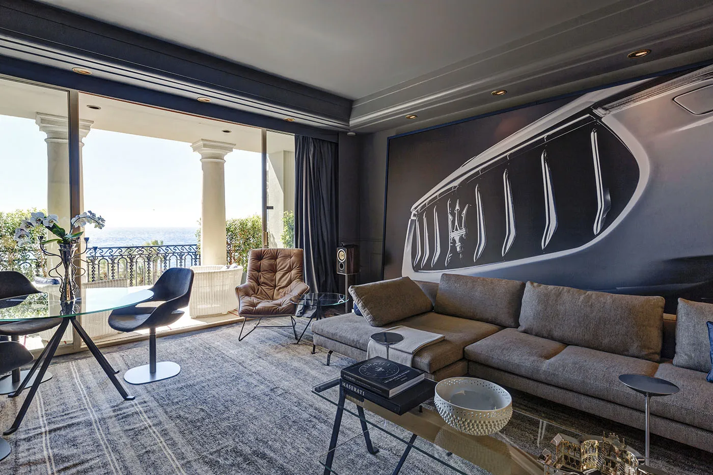 Automotive references become part of the room’s material and graphic character.